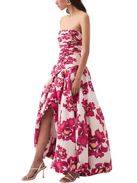 Thumbnail for Woman wearing a red floral strapless long bubble dress with a high slit on a white background