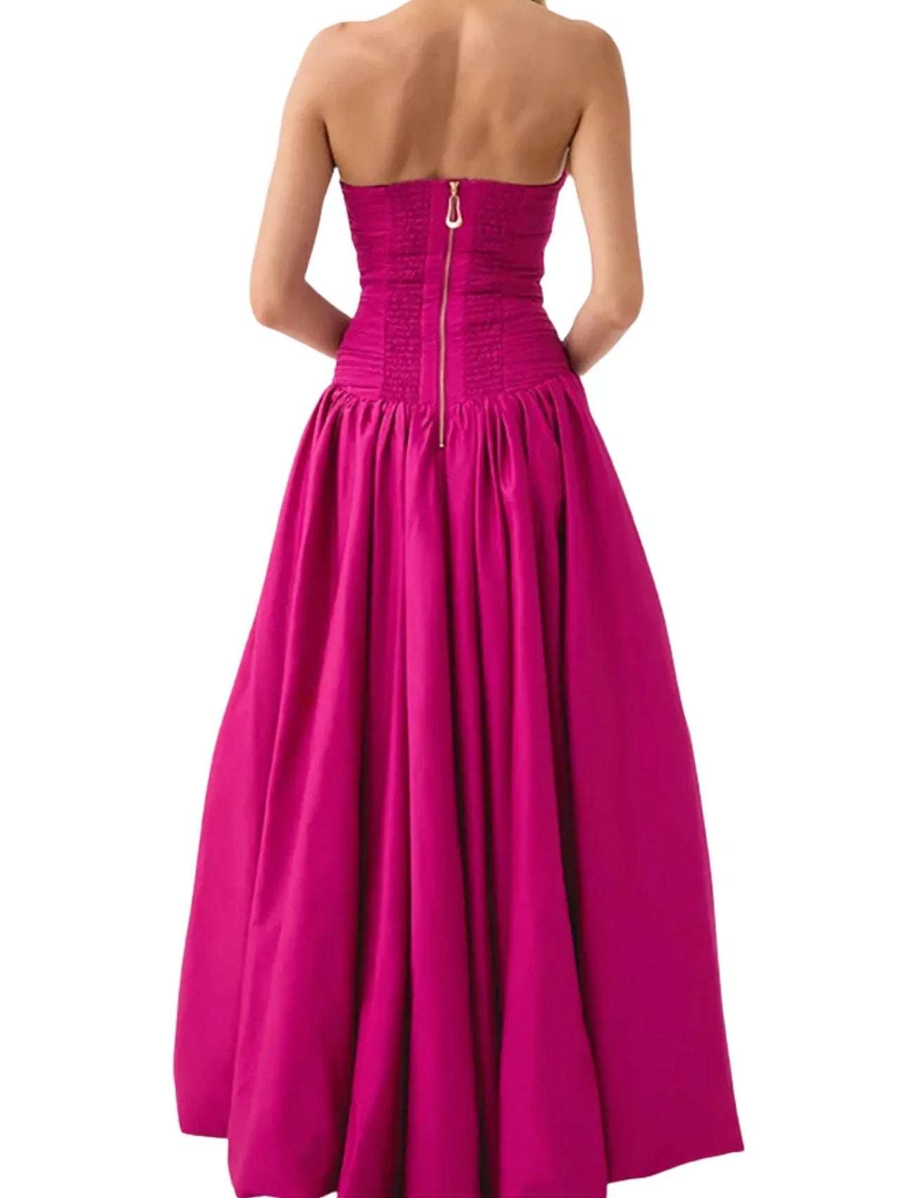 Woman wearing a deep pink strapless long bubble dress with a high slit on a white background