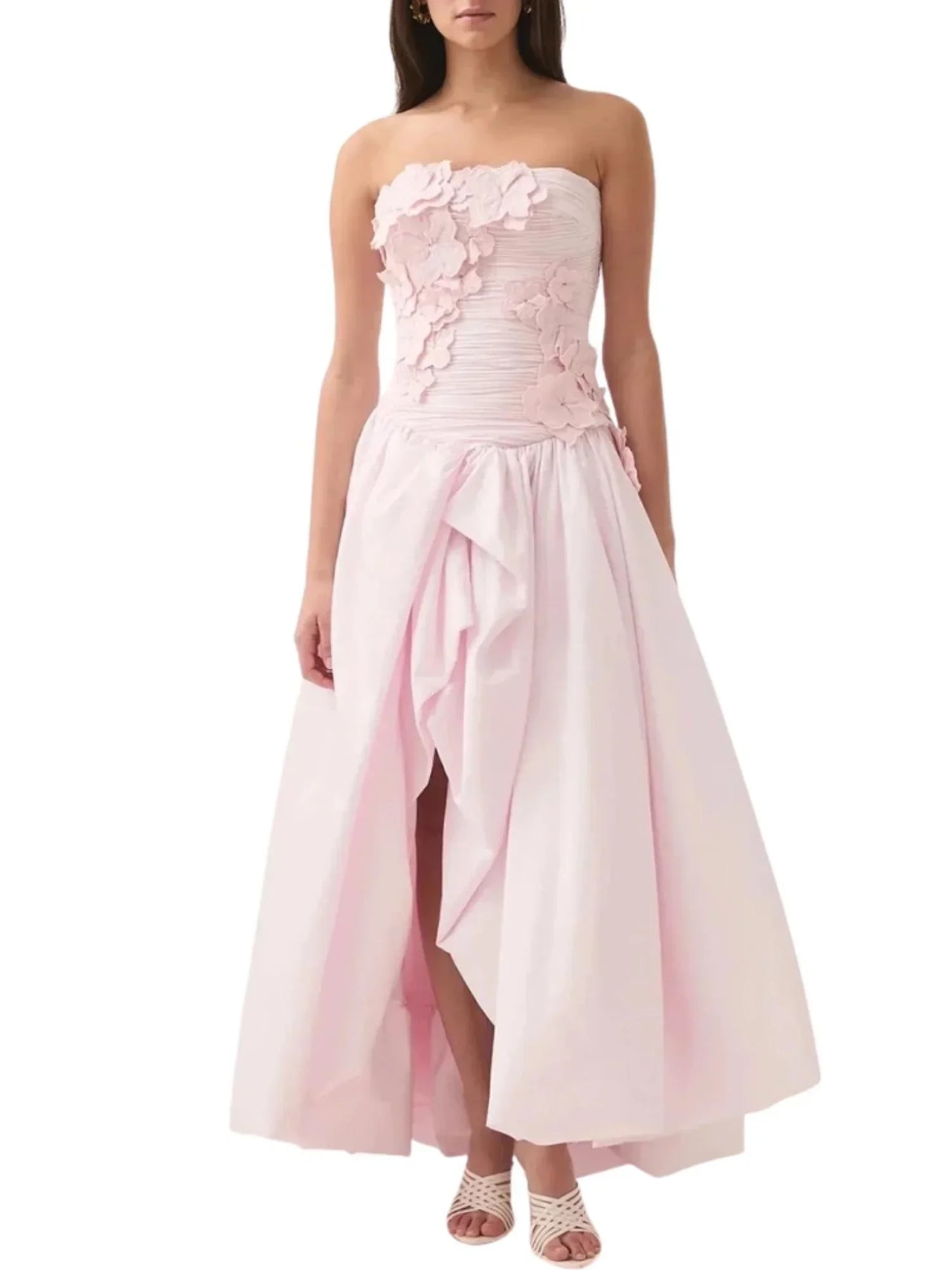 Pink strapless long bubble dress with high slit on a white background