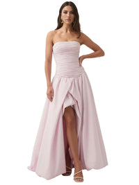 Thumbnail for Woman wearing a pink floral strapless long bubble dress with a high slit on a white background 
