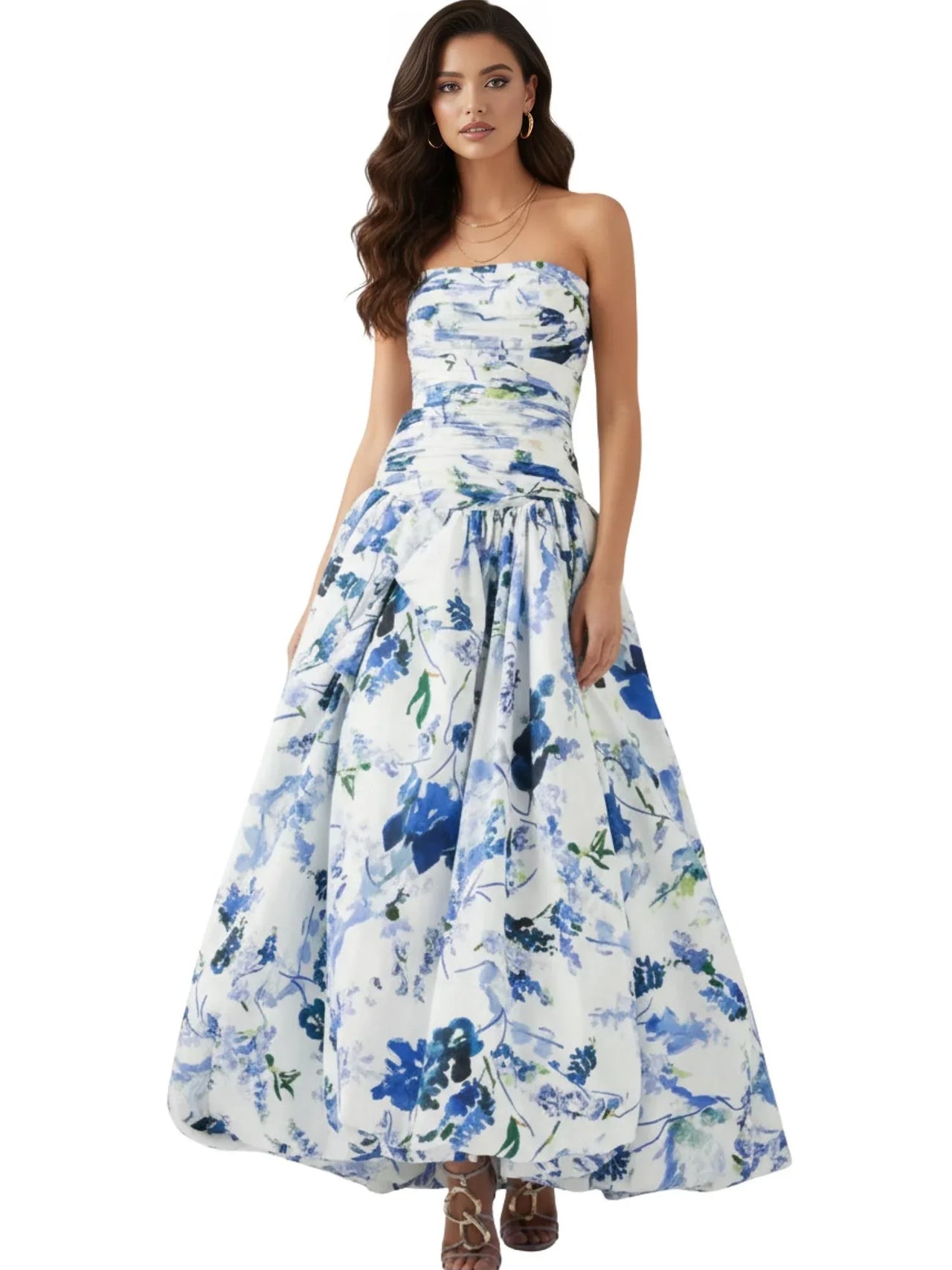 Woman wearing a floral strapless long bubble dress with blue and white flowers on a white background