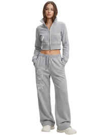 Thumbnail for Woman wearing a grey tracksuit set with a logo on a white background
