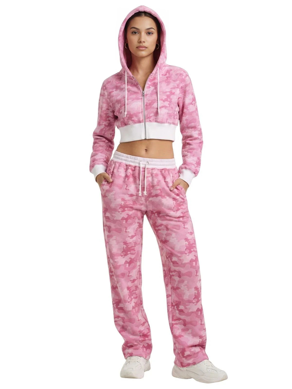 Woman wearing a pink tie-dye hoodie and pants tracksuit set on a white background