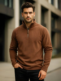 Thumbnail for Man wearing a brown quarter-zip sweater standing in an urban setting