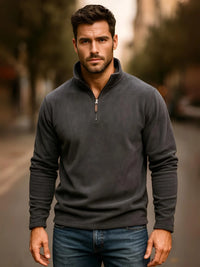Thumbnail for Man wearing a dark gray pullover with a blurred outdoor background