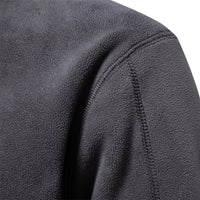 Thumbnail for Close-up of a textured gray fleece fabric with stitching detail.