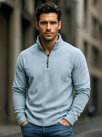 Thumbnail for Man wearing a light blue pullover with a blurred urban background