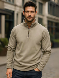 Thumbnail for Man wearing a light green fleece pullover with a blurred building background