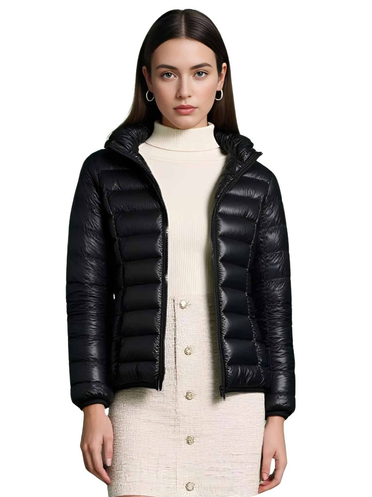 Woman wearing a black puffer jacket over a cream outfit on a white background