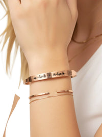 Thumbnail for Rose gold bracelet with engraved design on a wrist against a neutral background