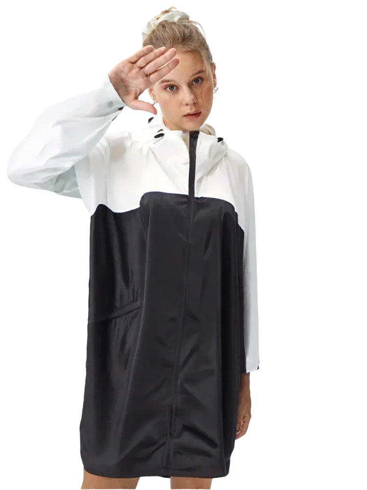 Child wearing a black and white raincoat on a white background