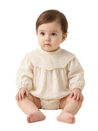 Thumbnail for Baby wearing a cream-colored romper with a ruffled collar on a white background