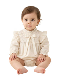 Thumbnail for Baby's vintage antique white long sleeved romper set with lace accents on a beige background.