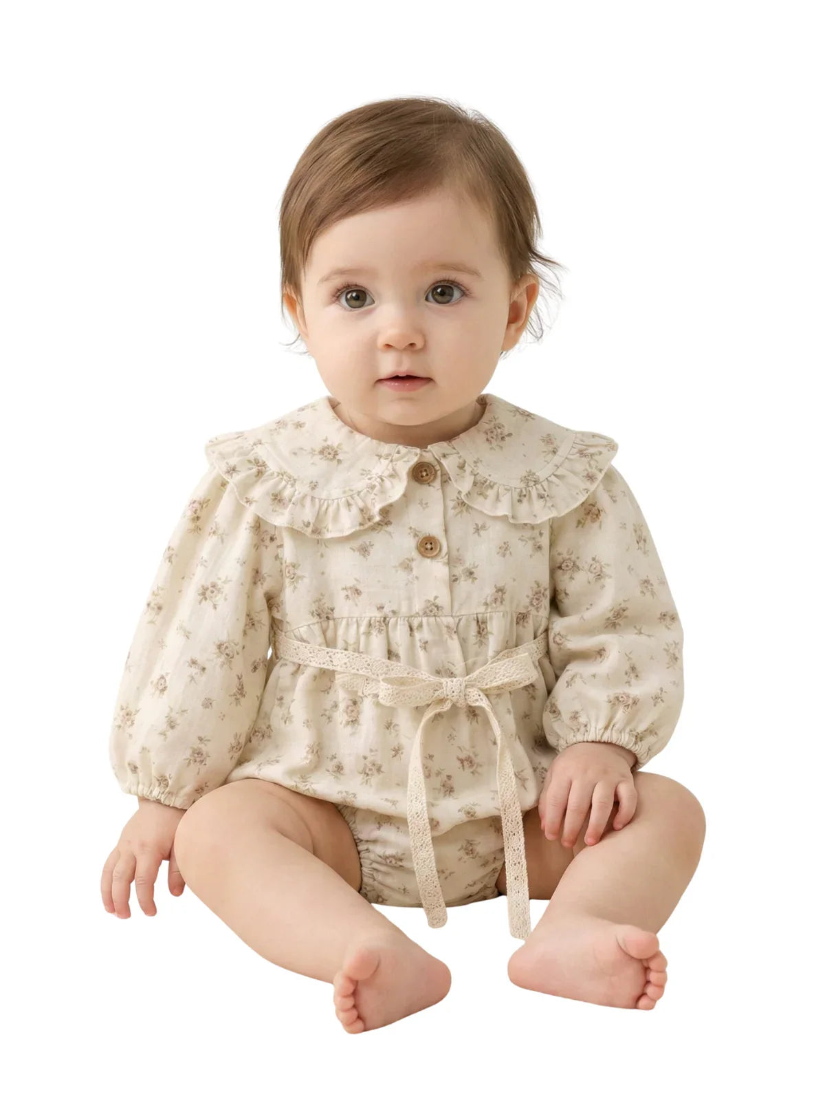 Baby wearing a cream floral romper with a white background
