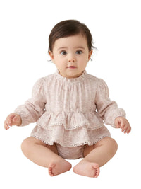 Thumbnail for Baby wearing a ruffled pink romper on a white background