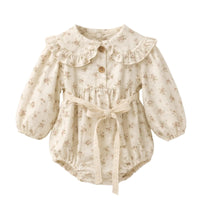 Thumbnail for Cream floral baby romper with ruffled collar on a white background