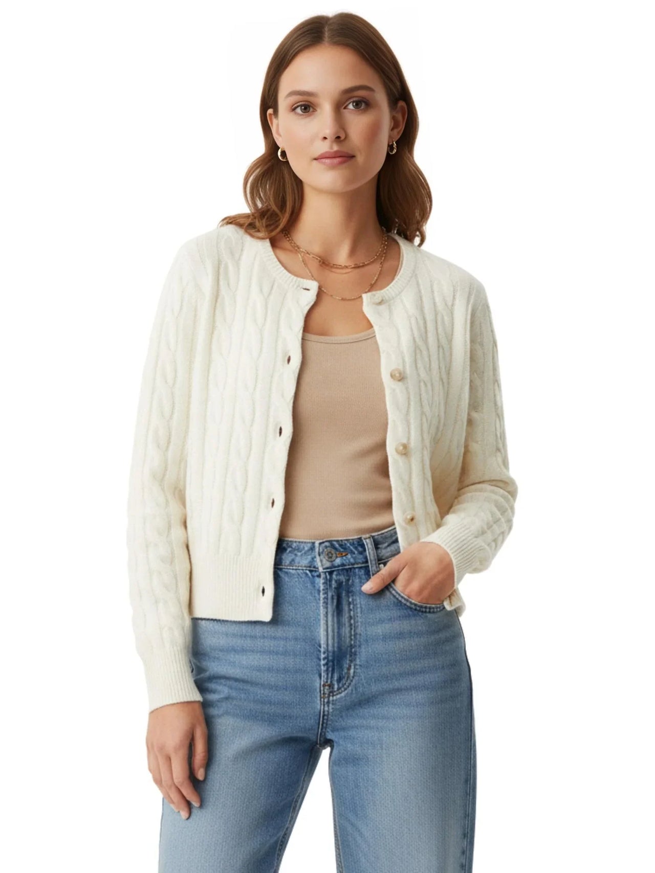 Woman wearing a white cable knit cardigan over a beige top and blue jeans on a white background