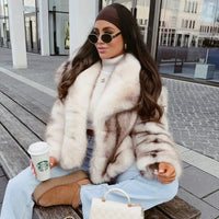 Thumbnail for Woman in a white striped faux fur coat holding a Starbucks cup outdoors