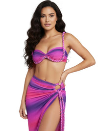 Thumbnail for Woman wearing a pink and purple bikini with a matching sarong on a white background