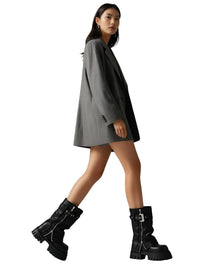 Thumbnail for Woman wearing a gray dress and black chunky boots on a white background