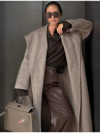 Thumbnail for Woman wearing a long camel waterfall coat with belt and shawl lapel on a white background