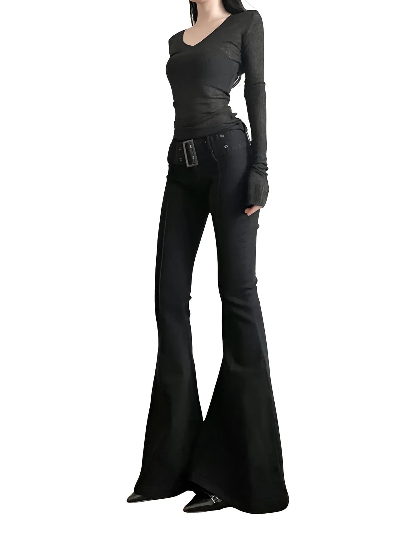 Person wearing a black outfit with black flared pants on a white background