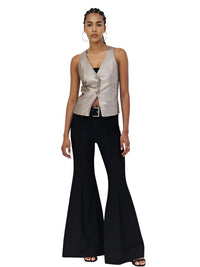 Thumbnail for Woman wearing a metallic sleeveless top and black flared pants on a white background