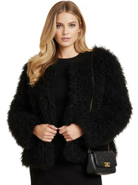 Thumbnail for Woman wearing a black faux fur coat with a handbag on a white background