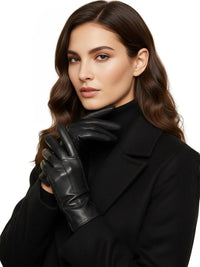 Thumbnail for Woman wearing a black coat and black leather gloves against a white background