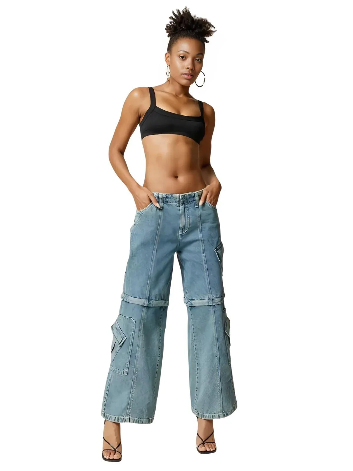 Woman wearing a black ribbed crop top and light blue cargo pants on a white background