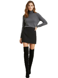 Thumbnail for Woman wearing a gray turtleneck sweater, black skirt, and black knee-high suede boots on a white background