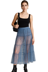 Thumbnail for Woman wearing a black top and blue lace skirt with a black handbag on a white background