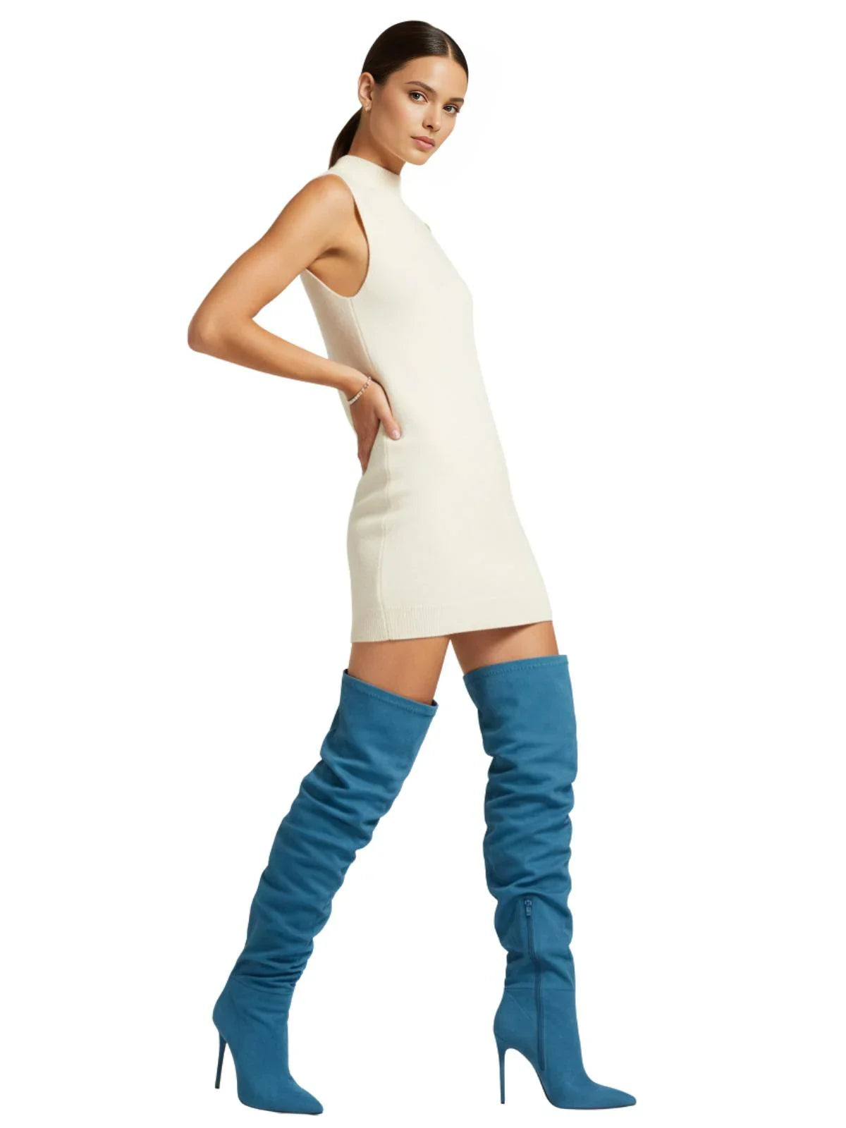 Woman wearing a white dress and blue over-the-knee-high suede boots on a white background