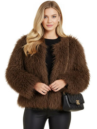 Thumbnail for Woman wearing a brown fluffy faux fur coat with a black handbag on a white background