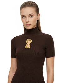 Thumbnail for Woman wearing a brown turtleneck top with a keyhole cutout on a white background
