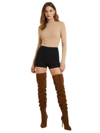 Thumbnail for Woman wearing a beige turtleneck sweater and black shorts with brown over-the-knee-high suede boots on a white background