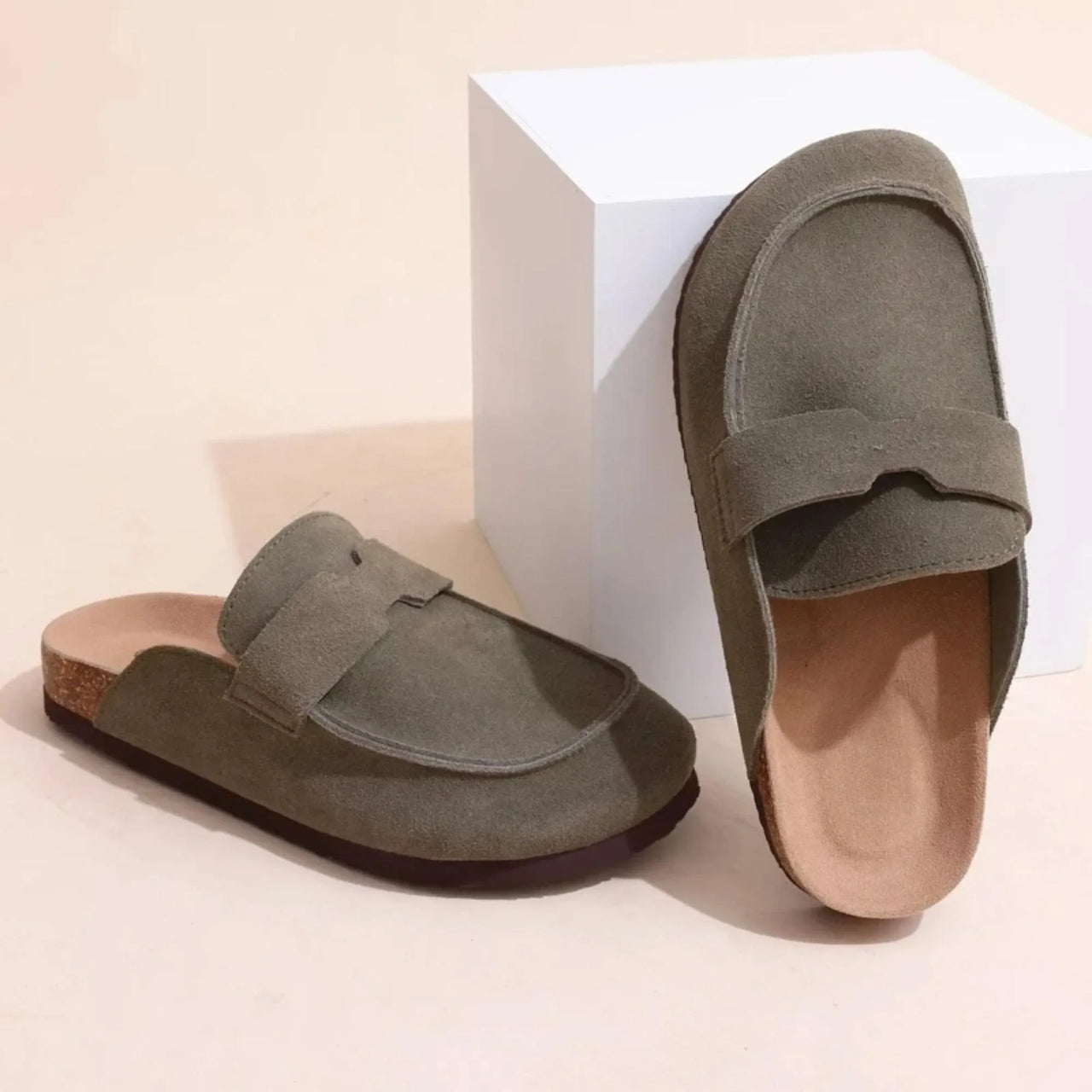 Pair of olive green Birkenstock style suede sandals on a white background