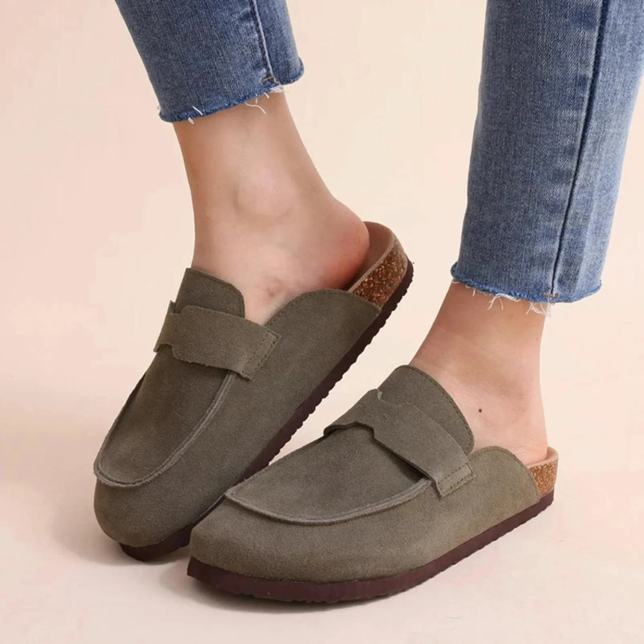 Pair of olive green Birkenstock style suede sandals on a white background