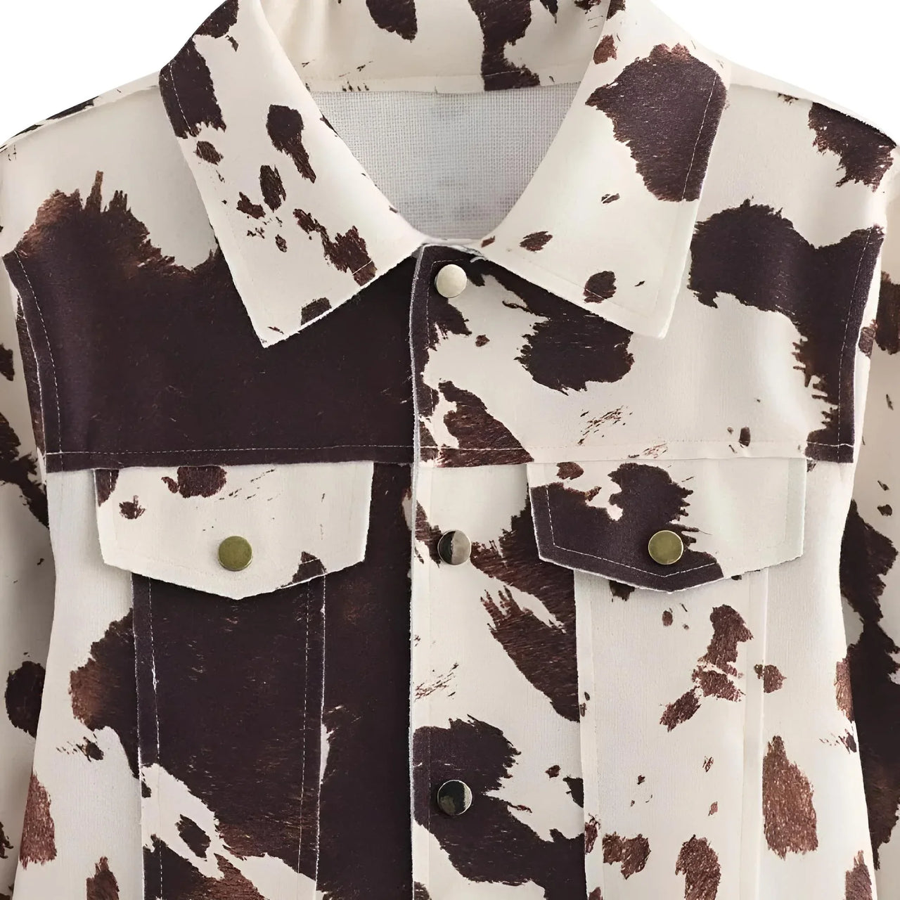 Cow print jacket with brown and white pattern on a plain background