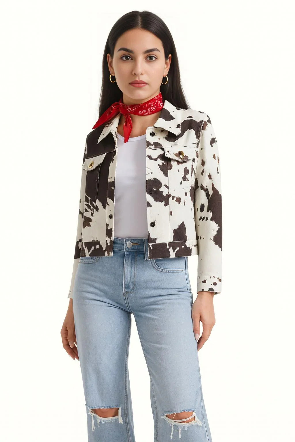 Woman wearing a cow print jacket, white top, and light blue jeans with a red bandana.