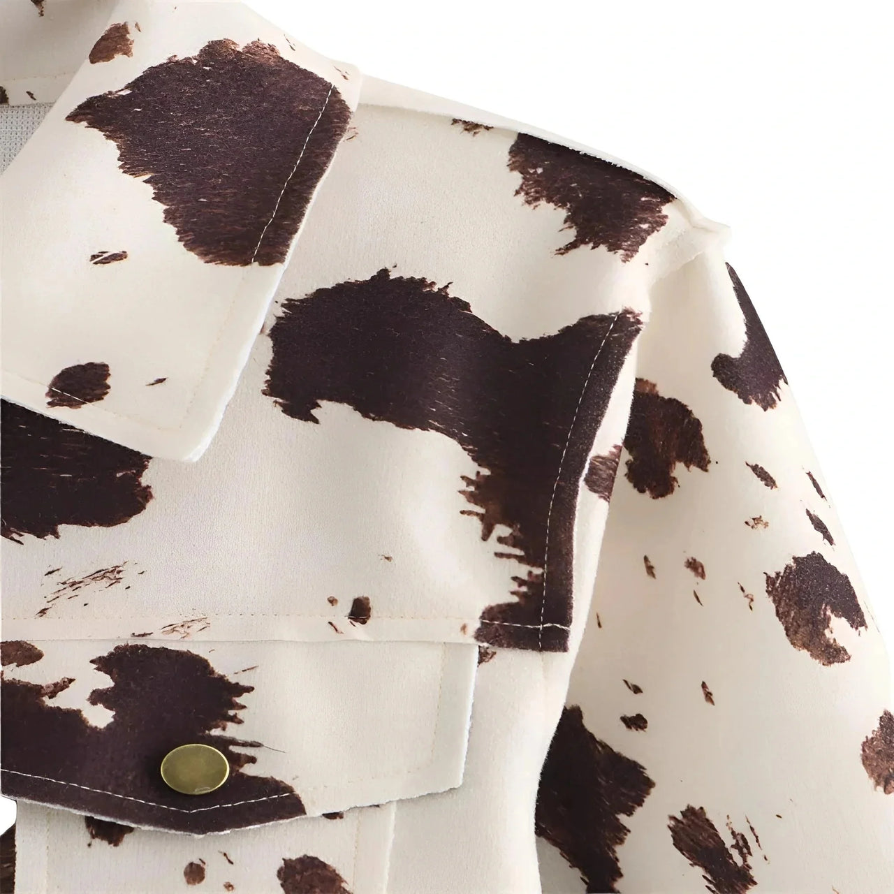 Close-up of a jacket with a cow print pattern on a white background