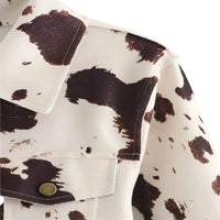 Thumbnail for Close-up of a jacket with a cow print pattern on a white background