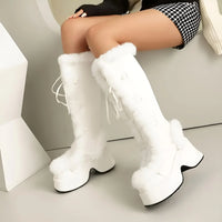 Thumbnail for White knee-high boots with fluffy texture worn by a person sitting on a white chair.
