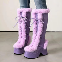 Thumbnail for Purple furry boots with laces worn by a person on a neutral background