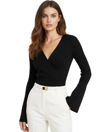 Thumbnail for Woman wearing a black v-neck sweater and white pants on a white background