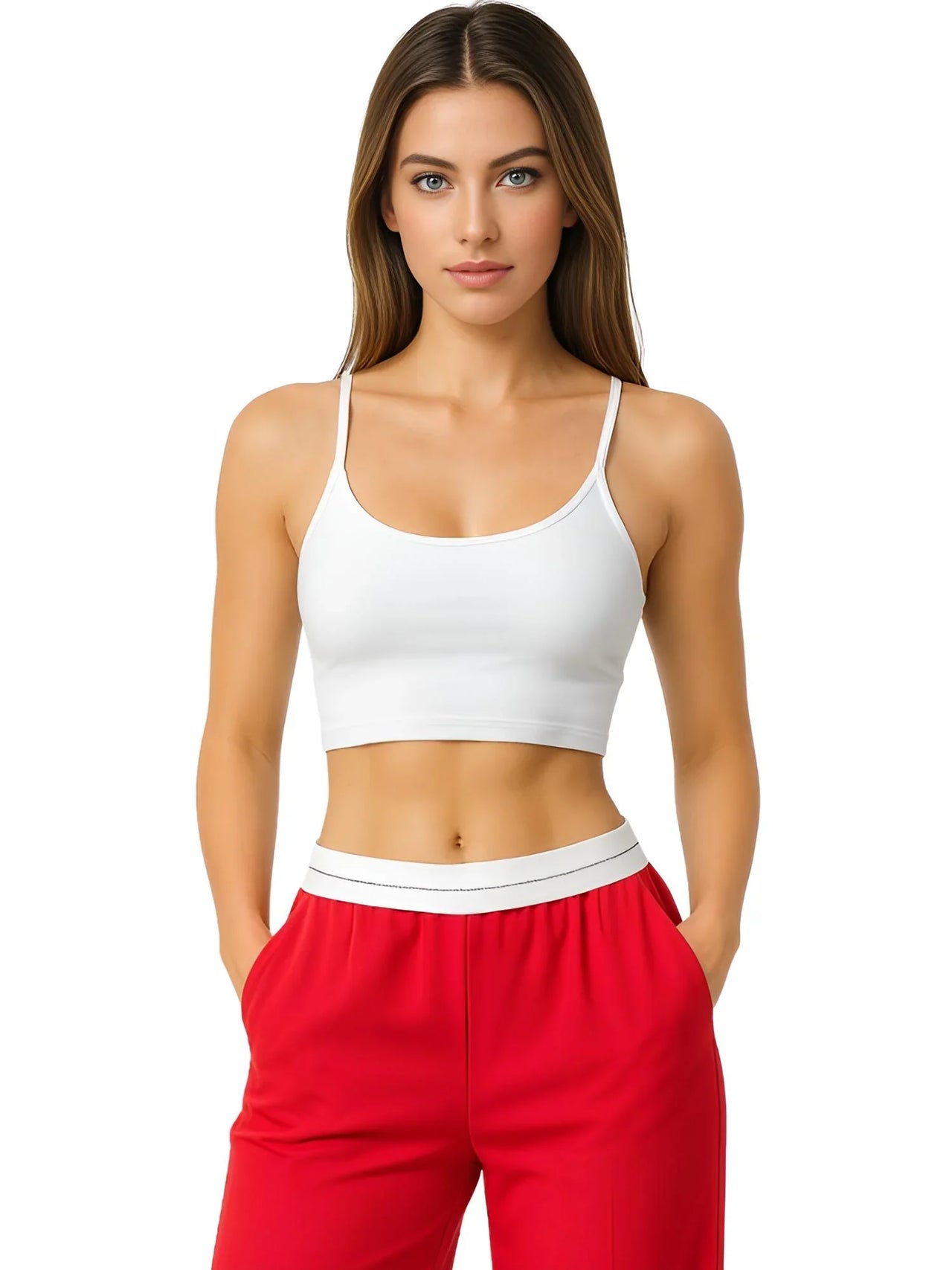 Woman wearing a white sports bra and red pants on a white background