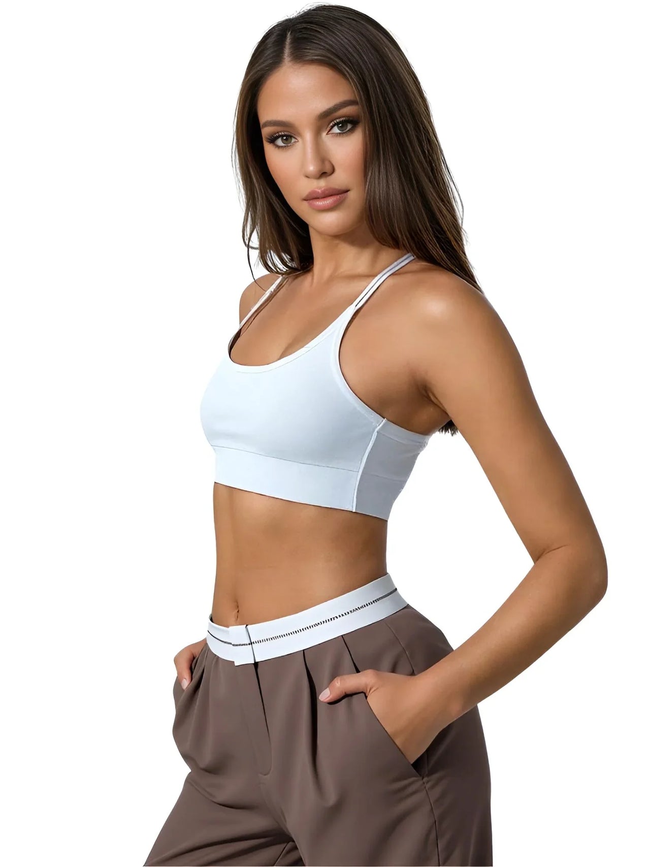 Woman wearing a white sports bra and brown pants on a white background