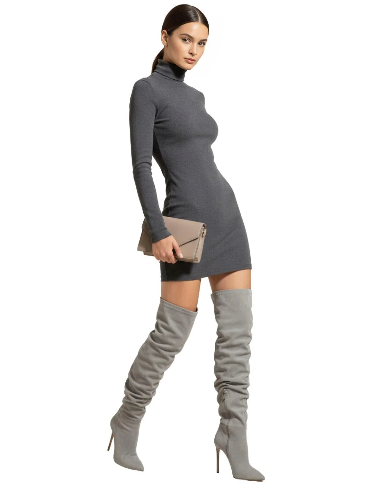 Woman wearing a grey dress and over-the knee-high suede boots on a white background