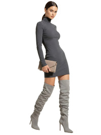 Thumbnail for Woman wearing a grey dress and over-the knee-high suede boots on a white background