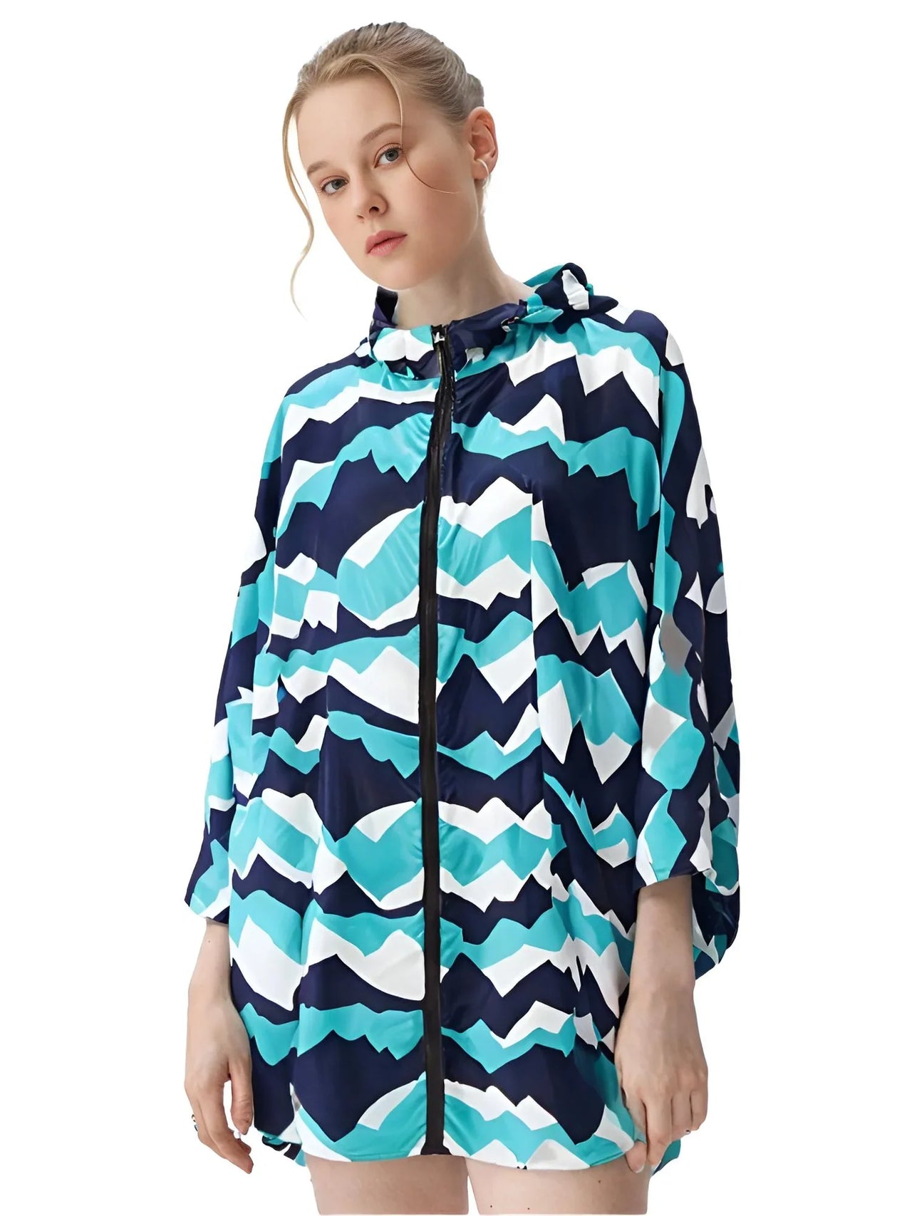 Woman wearing a navy teal and white patterned raincoat on a white background
